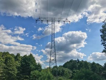 Low angle view of electricity pylon against sky