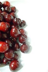 Close-up of red fruit over white background