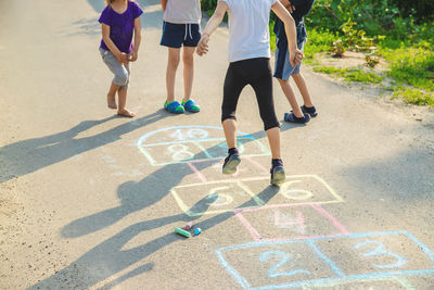 Low section of people walking on road