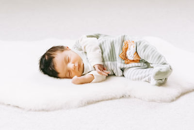 Cute baby sleeping on bed