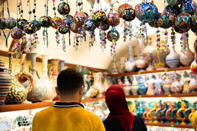 Rear view of people at market stall