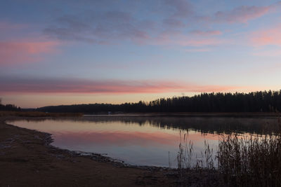 Scenic view of calm lake at sunset