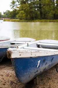 Close-up of old boat moored on shore