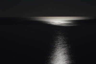 Scenic view of sea against sky at night