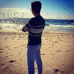 Rear view of man standing on beach