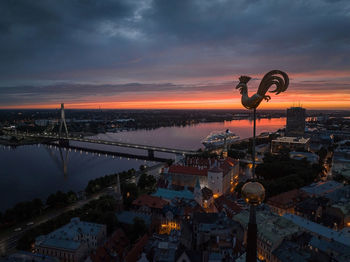 Symbol of old riga town - golden cockerel, rooster topping bell tower of riga