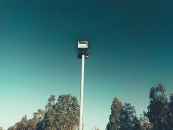 Low angle view of street light against clear blue sky