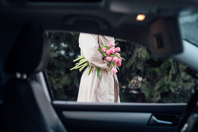 Midsection of woman holding bouquet