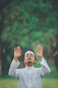 Religious muslim man praying  outdoor at quiet nature  environment sun beams.