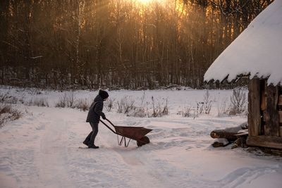 Kid on snow covered land 