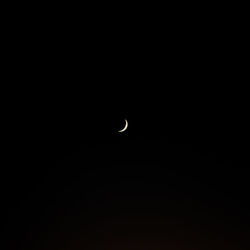 Low angle view of moon against sky at night