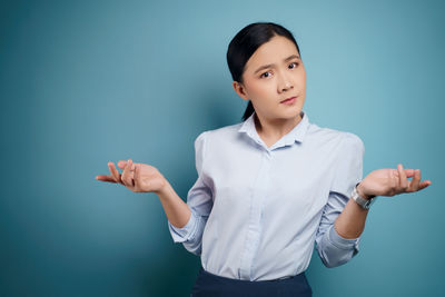 Full length of man standing against blue background