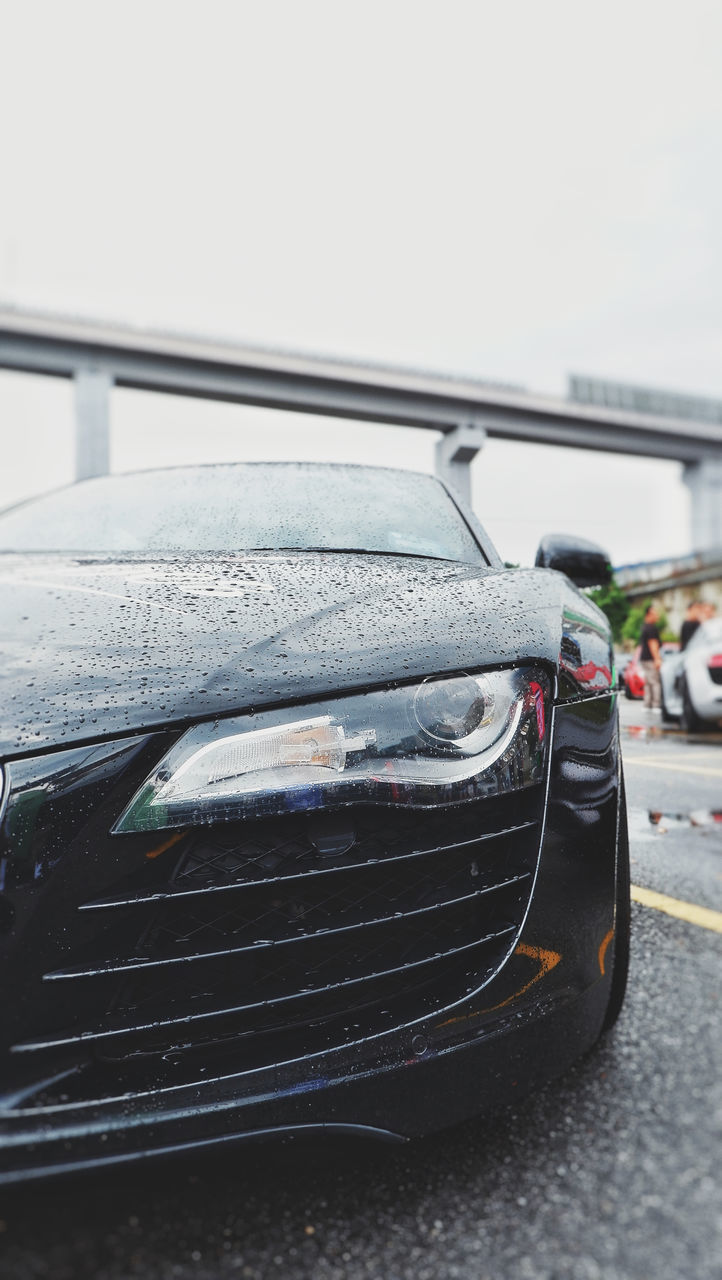 CLOSE-UP OF CARS ON STREET