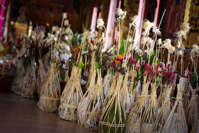 Tilt shot of flower bouquets at temple during festival