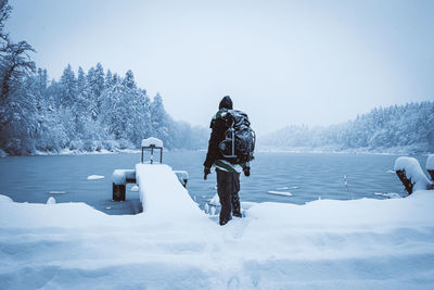 Rear view of man on snow covered land