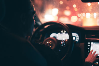 Rear view of woman driving car