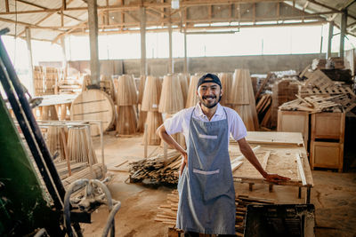 Portrait of young man standing in market