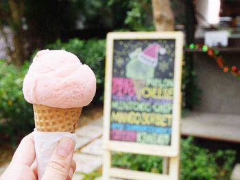 Close-up of hand holding ice cream cone