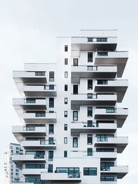 Low angle view of apartment building against sky
