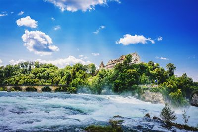 Scenic view of waterfall against sky