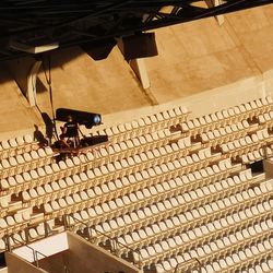 High angle view of man by lighting equipment at stadium