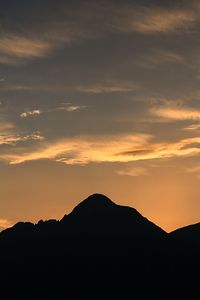 Scenic view of silhouette mountains against sky during sunset