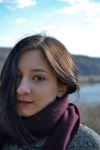 Close-up portrait of girl against sky