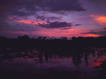Scenic view of lake against romantic sky at sunset