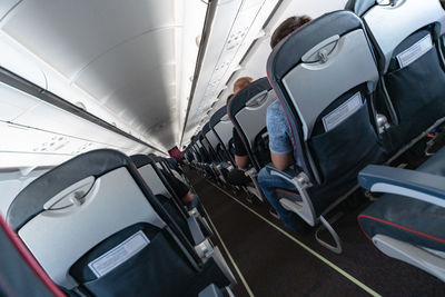 Rear view of man traveling in airplane