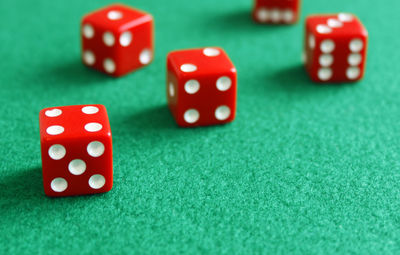 High angle view of dice on green table