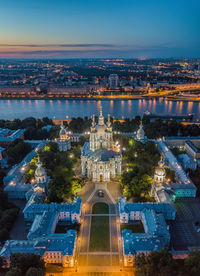 Aerial view of illuminated cityscape against sky