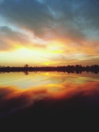 Scenic view of lake at sunset