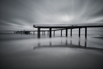 Pier over sea against sky