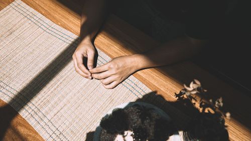 High angle view of hands on floor