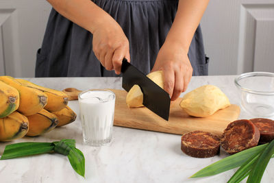 Midsection of man preparing food on table