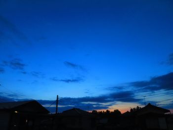 Low angle view of silhouette buildings against sky