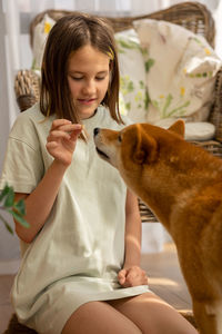 Portrait of little girl playing with her dog husky on sunny day