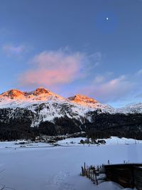 Scenic view of snowcapped mountains against sky during sunset