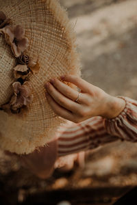 Close-up of woman holding hat