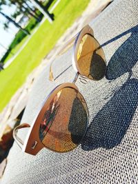 Low section of man wearing sunglasses on grass