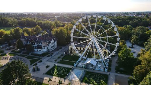 High angle view of ferris wheel in city against sky