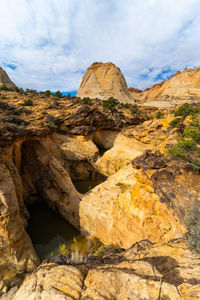 Low angle view of rock formations against sky