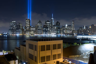 Illuminated cityscape against sky at night