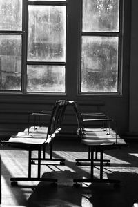 Empty chairs and table in building