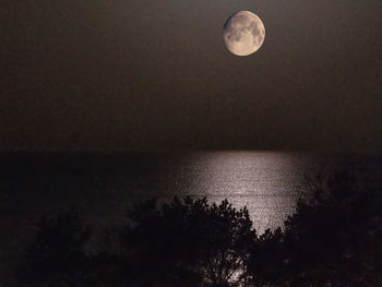 Scenic view of sea against sky at night