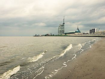 View of beach against cloudy sky