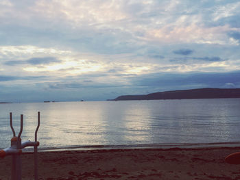 Scenic view of beach against sky during sunset