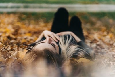 Midsection of woman lying on field