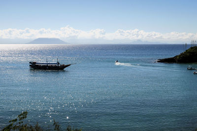 Sailboat in sea against sky