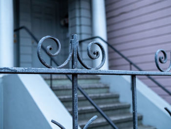 Close-up of metal fence against building